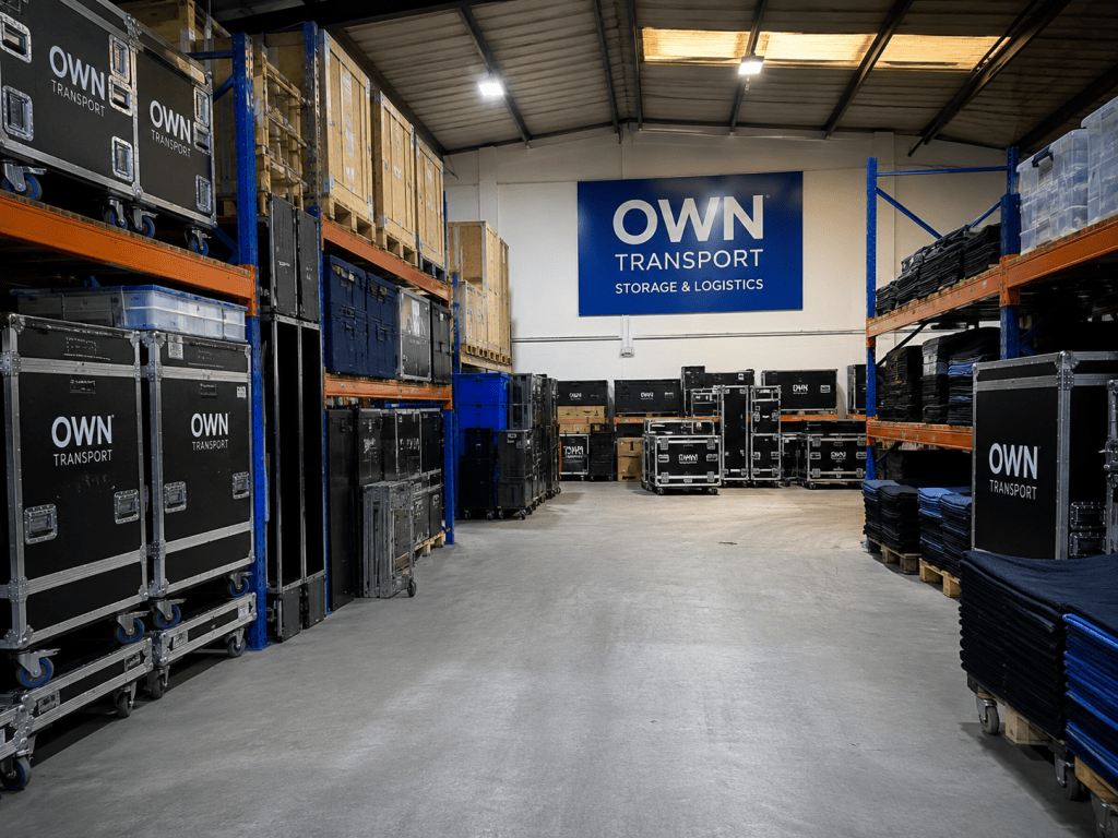 OWN Transport warehouse with event equipment, flight cases and secure storage racks.